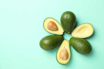 Ripe fresh avocado on mint background, top view