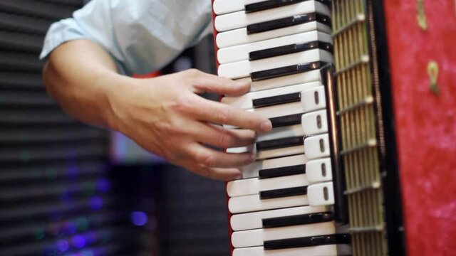 a man plays an accordion
