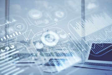 Computer on desktop in office with technology theme hologram. Multi exposure. Tech concept.