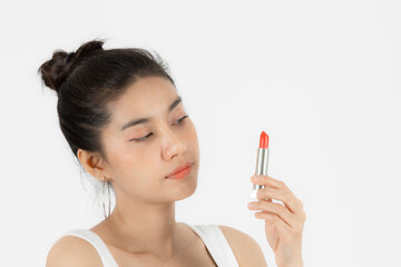 Healthy and cosmetics concept. Beauty face of young Asian woman applying make up with lipstick over white isolated background.