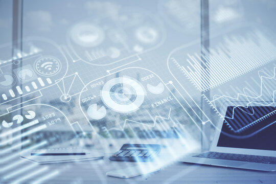 Computer on desktop in office with technology theme hologram. Multi exposure. Tech concept.