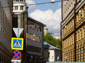 Obraz premium City street with residential buildings of an old construction and a modern office building
