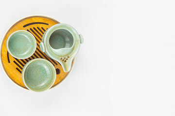 A Chinese traditional tea set, including teapot, cups, and plate. 