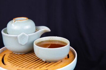 A set of Chinese traditional pottery teapot and cups, serving black tea.