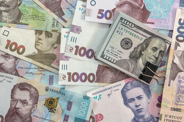 Ukrainian currency hryvnia with usa dollar as background. money exchange concept