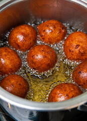 Homemade donuts making boiling in hot oil