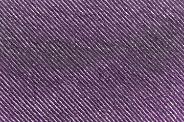textile, party and texture concept - shimmering violet fabric background
