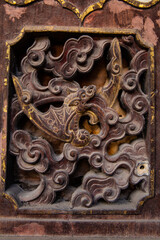 Traditional Chinese wooden sculpture on vintage windows. 