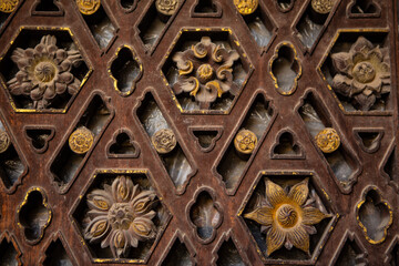 Traditional Chinese wooden sculpture on vintage windows. 