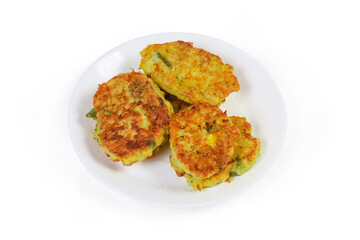Savory rice fritters with vegetables on dish on white background