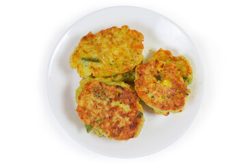 Savory rice fritters with vegetables on dish, top view