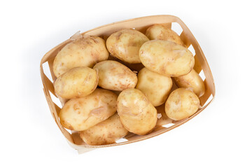 Top view of raw young potatoes in small wooden basket