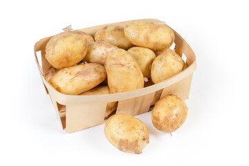 Raw yellow young potatoes with skin in small wooden basket