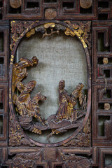 Traditional Chinese wooden sculpture on vintage windows. 