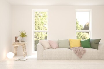 White living room with sofa and summer landscape in window. Scandinavian interior design. 3D illustration