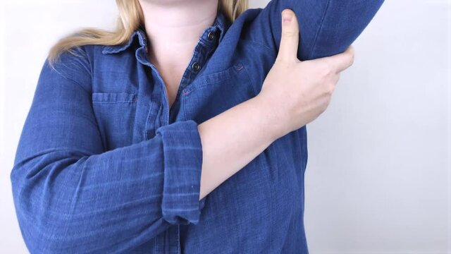 A woman suffers from pain in the armpit. Sweating, unpleasant odor, redness, itching and inflammation in the armpit. Breast Cancer Prevention Concept