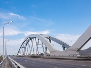 Obraz premium Part of road and railroad bridge with steel arches
