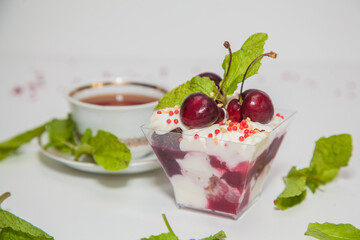 Beautiful dessert with cherries, whipped cream and mint