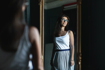 Beautiful smiling young woman with fresh skin of face posing in a room