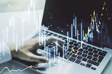 Multi exposure of abstract financial diagram with hand typing on computer keyboard on background, banking and accounting concept