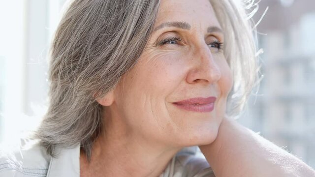 Beautiful wrinkled woman sincerely smiling, enjoying happy active life, aging