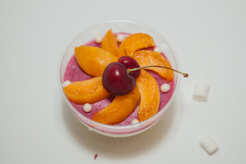Beautiful dessert with berries: cherry, peaches and mint
