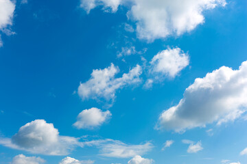 White clouds on blue sky background.