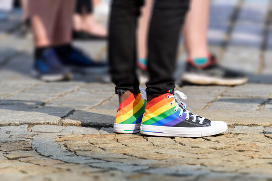 young man in a sneakers with rainbow symbol of LGBT. LGBTQ+