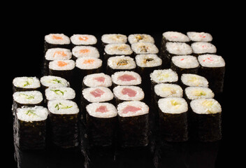 large set of sushi on a black background.А traditional dish of Asian cuisine.
