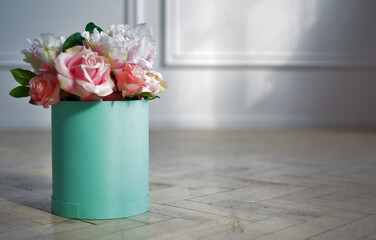Beautiful flowers, peonies in a box of turquoise color. Women's holidays