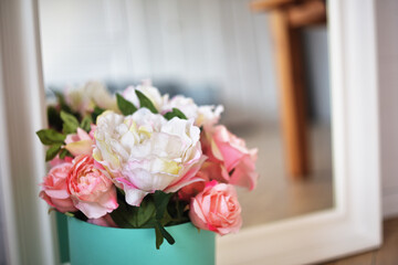 Beautiful flowers, peonies in a box of turquoise color. Women's holidays