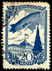 Russia, circa 1936: A stamp printed in USSR shows a dirigible over the Moscow Kremlin