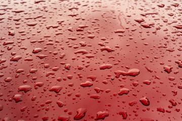 Drops of water on a red surface