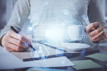 Social network theme hologram over hands taking notes background. Concept of global international people connect. Double exposure