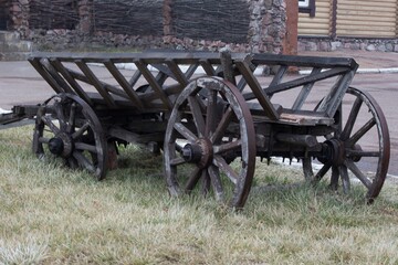Fototapeta na wymiar Old wooden carriage on lawn