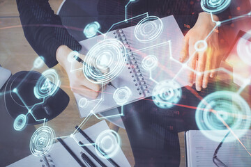 Social network theme hologram over hands taking notes background. Concept of global international people connect. Double exposure