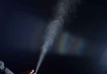 Spray, hair spray on a black background, dust, air