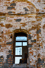 Fototapeta na wymiar Window hole in the ancient building. Ancient house restoration