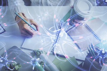 Neuron hologram over hands taking notes background. Concept of research and study. Double exposure