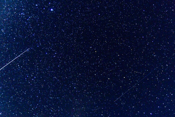 Background of the night sky with many stars. Satellite trajectory