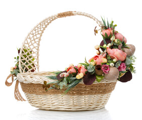 Fototapeta na wymiar Wicker design baskets are decorated with a floral arrangement for Easter. On a white background.