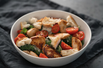 Caesar salad alternative with kale and turkey in white bowl