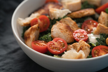 Caesar salad alternative with kale and turkey in white bowl