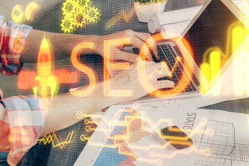 Multi exposure of seo icon with man working on computer on background. Concept of search engine...