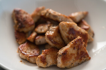 fried chicken fillet slices in white bowl