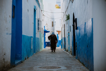 Asilah, Morocco - 19 September 2019: A narrow street in with blue & white & red style.
