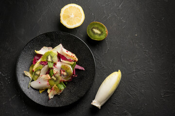 mixed salad with kiwi lettuce beet chicory and lemon juice