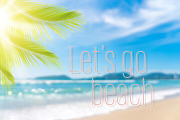 Let's go beach words on blur tropical beach with bokeh sunlight wave abstract background.