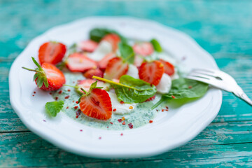 A healthy and delicious salad made from fresh strawberries and mozzarella.