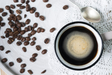 Fototapeta premium Coffee in a mug and some coffee beans in the background.